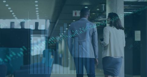 Coworkers Walking in Corridor with Data Overlay Illustrating Business Concepts