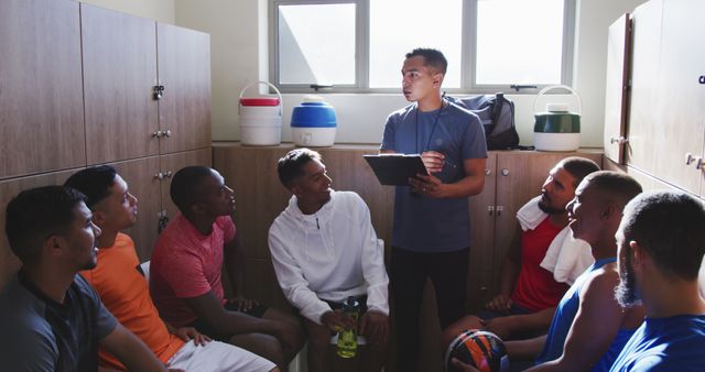 Diverse male football players discussing game with coach in changing room - Download Free Stock Photos Pikwizard.com