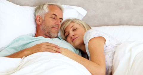 Senior Couple Cuddling in Cosy Bedroom Setting