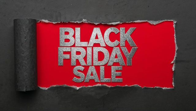 Black Friday Sale Revealing Silver Glitter Text through Torn Black Paper Banner