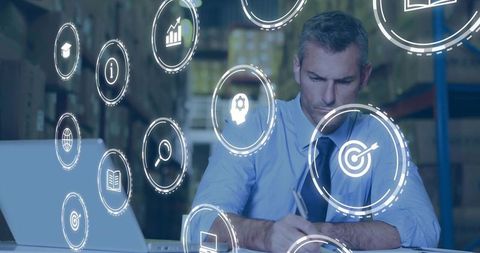 Warehouse manager analyzing logistics data with holographic analytics icons for planning