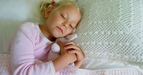 Peaceful child sleeping with stuffed animal in calm setting