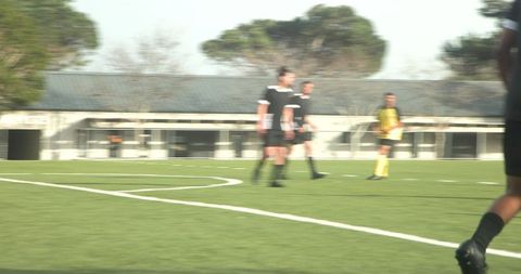 Soccer Players Engaged in Practice Session on Sunny Field
