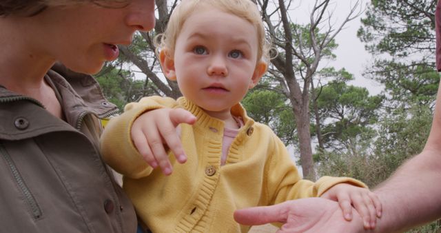 Toddler Pointing While Outside with Parents - Download Free Stock Images Pikwizard.com