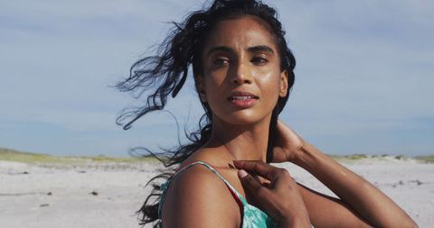 Relaxed Woman Enjoying Sun and Wind on Beach Day