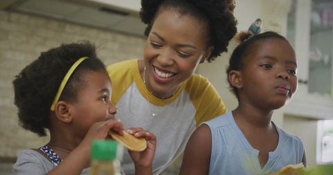Mother and Daughters Enjoying Breakfast Together
