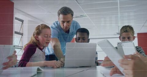 teacher guiding diverse students on laptops with digital graph overlay - Download Free Stock Images Pikwizard.com