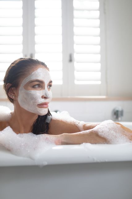Beautiful Woman Relaxing in Bathtub with Face Mask - Download Free Stock Photos Pikwizard.com