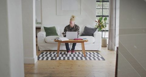 Man Typing on Laptop in Minimalist Home Office