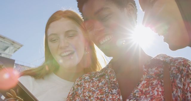 Joyful Diverse Friends Laughing Together Outdoors in Sunlight - Download Free Stock Images Pikwizard.com