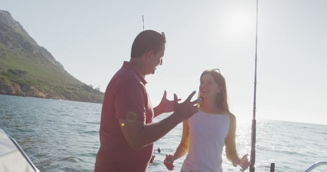Couple delighting in a sunny day on a boat while fishing at the sea. Ideal for depicting leisure activities, outdoor adventures, vacation getaways, and aims to showcase relaxation and quality time. May be used in travel brochures, fishing equipment ads, and lifestyle blogs.