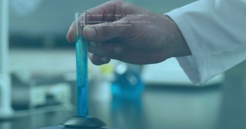 Scientist analyzing blue liquid in laboratory environment