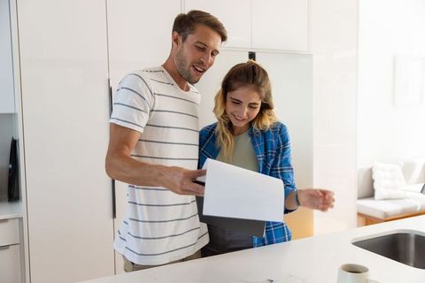 Couple reviewing documents in contemporary kitchen setting