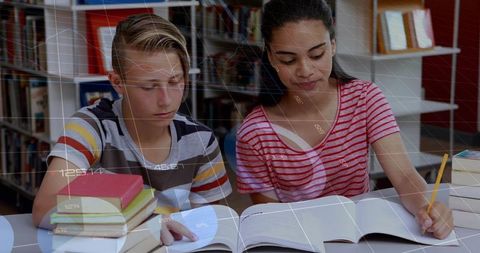 Teen students studying together in library reading textbooks and taking notes for homework