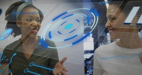 Professional women collaborating with augmented reality interface in modern office