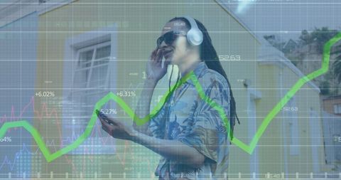 Young Man in Urban Area Uses Smartphone with Financial Data Overlay