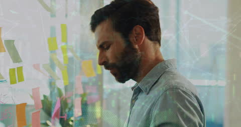 Caucasian Businessman Analyzing Data in Modern Office