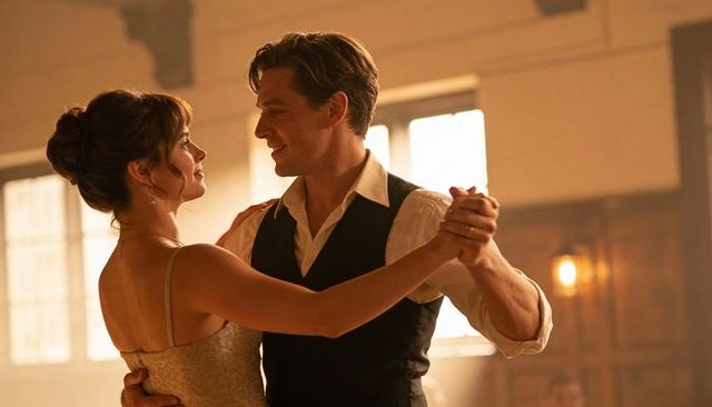 Backlit couple dancing ballroom waltz showing intimate romance and vintage elegance