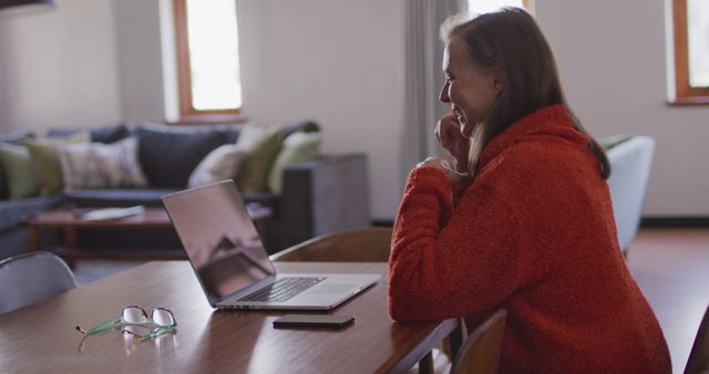 Woman Working from Home on Laptop Sitting at Table in Cozy Living Room - Download Free Stock Images Pikwizard.com