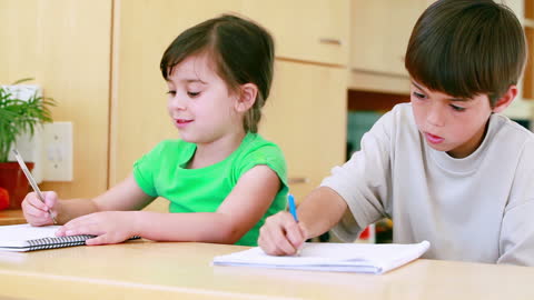 Children Doing Homework Together in Kitchen Learning Environment