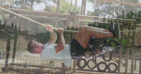 Determined Athlete on Forest Obstacle Course Rope Climbing