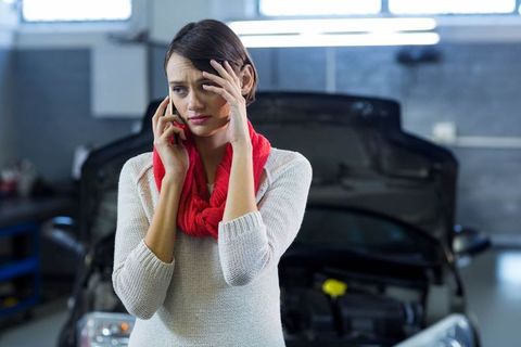 Stressed Young Woman Contacting Mechanic for Car Troubleshooting