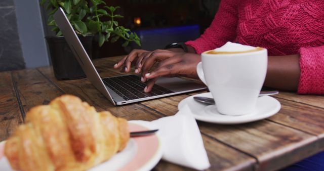 Person Typing on Laptop in Café with Coffee and Croissant - Download Free Stock Images Pikwizard.com