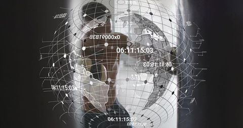 Executive viewing holographic globe display of global data and network grid in modern office
