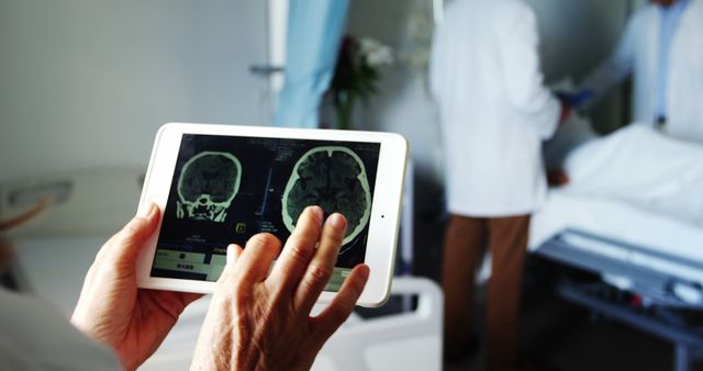 Doctor using a tablet to view brain scans in a hospital room. Useful for depicting modern medical technology, patient care, healthcare advancements, and neurology for medical advertisements, educational materials, and healthcare articles.