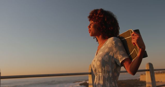 Woman Reflecting While Carrying a Surfboard at Sunset by the Ocean - Download Free Stock Images Pikwizard.com