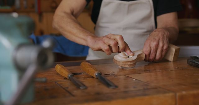 Craftsman Carving Wood in Workshop with Chisels and Wooden Sculptures - Download Free Stock Images Pikwizard.com