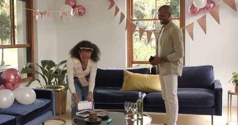 Diverse Couple Celebrating Occasion with Cake at Home