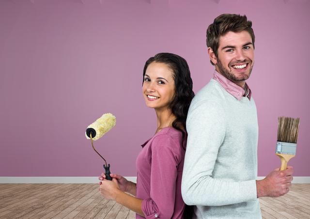 Digital composite of Couple with paintbrush and roller in room