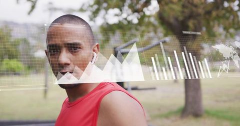 Athlete wearing earbuds monitoring holographic fitness data overlay during outdoor run in park