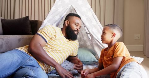 Father Bonding with Son in Playful Home Tent Activity
