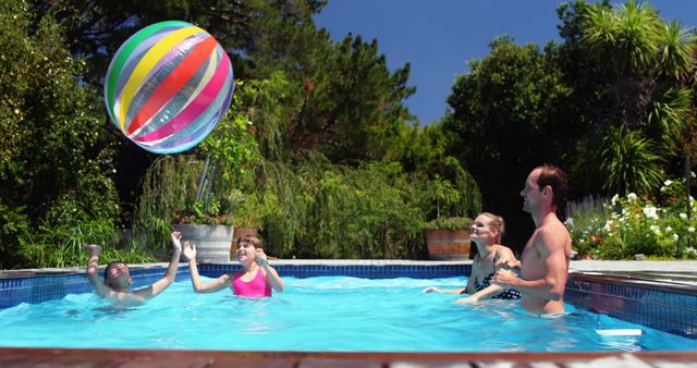 Family Enjoying a Fun Day in Backyard Pool with Colorful Beach Ball - Download Free Stock Images Pikwizard.com