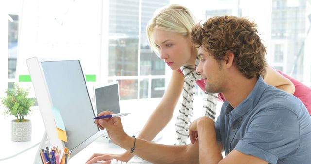 Young Professionals Collaborating on Desktop Computer in Bright Office - Download Free Stock Images Pikwizard.com