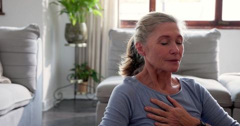 Senior woman practicing mindfulness breathing with tranquil expression
