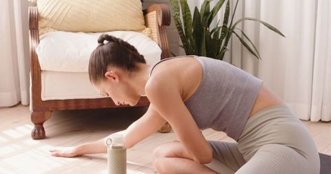 Woman Practicing Yoga Stretch at Home Living Room Wellness