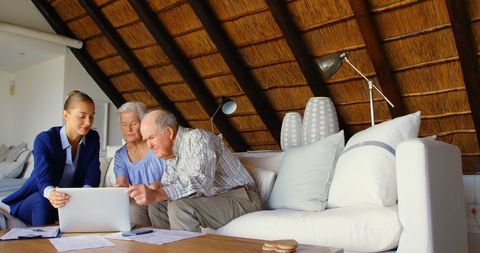 Senior couple consulting doctor at cozy home