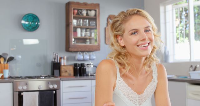 Smiling Woman Enjoying Morning in Bright Modern Kitchen - Download Free Stock Images Pikwizard.com