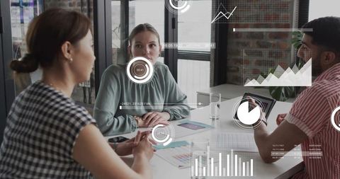 Listening woman watching colleague presenting tablet data in collaborative meeting with analytics