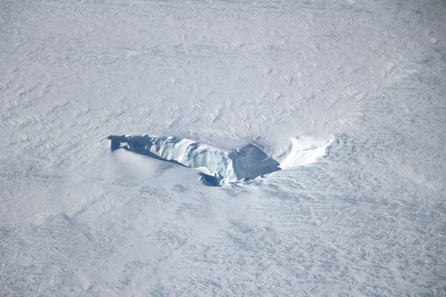 Scientists and crew with NASA’s Operation IceBridge, which makes annual aerial surveys of polar ice, are wrapping up their seventh campaign over the Arctic. In spring 2015, the team began using a different research aircraft—an adapted C-130 Hercules. They also added four new high-priority targets in the rapidly changing region of northeast Greenland.  Many of the flights, however, were routine. And that’s exactly the point; making measurements over the same path each year provides continuity between NASA’s Ice, Cloud, and Land Elevation Satellite (ICESat) missions—the first of which ended in 2009 and the second of which is scheduled for launch in 2017. Repeat measurements show how a landscape changes over time.  One area that has been surveyed repeatedly is northern Greenland’s Ryder Glacier. This photograph, taken during the IceBridge flight on May 6, 2015, shows a large moulin—dozens of meters across—atop this glacier. Moulins are holes in the ice sheet that drain melt water from the ice sheet’s surface to the bottom or out to the sea. Scientists are working to figure out what happens to melt water once it enters a moulin.  Read more: <a href="http://earthobservatory.nasa.gov/IOTD/view.php?id=85858&amp;eocn=home&amp;eoci=iotd_title" rel="nofollow">earthobservatory.nasa.gov/IOTD/view.php?id=85858&amp;eocn...</a>  Credit: <b><a href="http://www.earthobservatory.nasa.gov/" rel="nofollow"> NASA Earth Observatory</a></b>  <b><a href="http://www.nasa.gov/audience/formedia/features/MP_Photo_Guidelines.html" rel="nofollow">NASA image use policy.</a></b>  <b><a href="http://www.nasa.gov/centers/goddard/home/index.html" rel="nofollow">NASA Goddard Space Flight Center</a></b> enables NASA’s mission through four scientific endeavors: Earth Science, Heliophysics, Solar System Exploration, and Astrophysics. Goddard plays a leading role in NASA’s accomplishments by contributing compelling scientific knowledge to advance the Agency’s mission.  <b>Follow us on <a href="http://twitter.com/NASAGoddardPix" rel="nofollow">Twitter</a></b>  <b>Like us on <a href="http://www.facebook.com/pages/Greenbelt-MD/NASA-Goddard/395013845897?ref=tsd" rel="nofollow">Facebook</a></b>  <b>Find us on <a href="http://instagrid.me/nasagoddard/?vm=grid" rel="nofollow">Instagram</a></b>