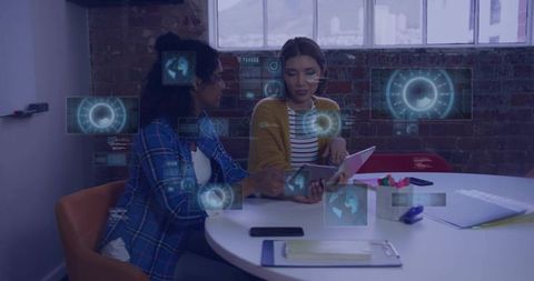 Women collaborating with tablet and holographic ar interfaces in modern coworking office