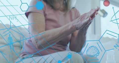 Senior Woman Disinfecting Hands with Medical Overlay