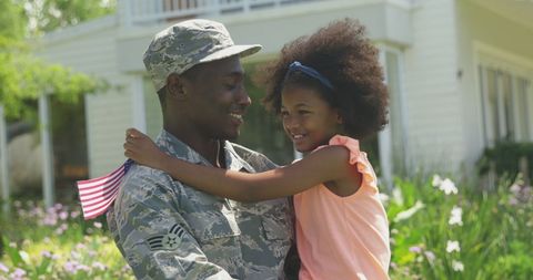 Homecoming Joy: Soldier Embracing Daughter with American Flag - Download Free Stock Images Pikwizard.com