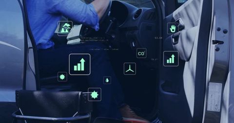 Seated driver checking digital dashboard with green telemetry icons in parked car interior