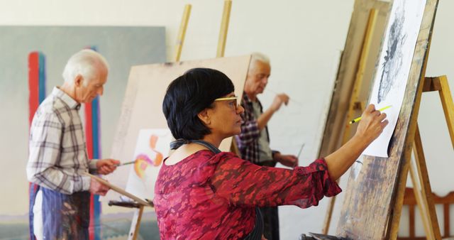 Mature adults enthusiastically learning to paint, led by passionate instructor. Ideal for content promoting lifelong learning, senior activities, retirement hobbies, creative workshops, and educational programs for elderly community engagement.