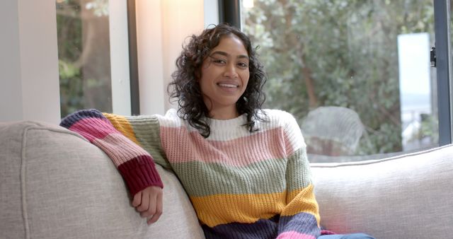 Smiling Woman Relaxing on Sofa by Window in Cozy Living Room - Download Free Stock Images Pikwizard.com