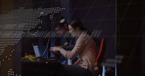 Technicians configuring network in high-tech server room